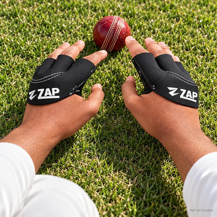 Cricketer wearing ZAP black fielding gloves while catching a cricket ball