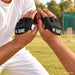 Cricketer using ZAP black fielding gloves during a low fielding catch
