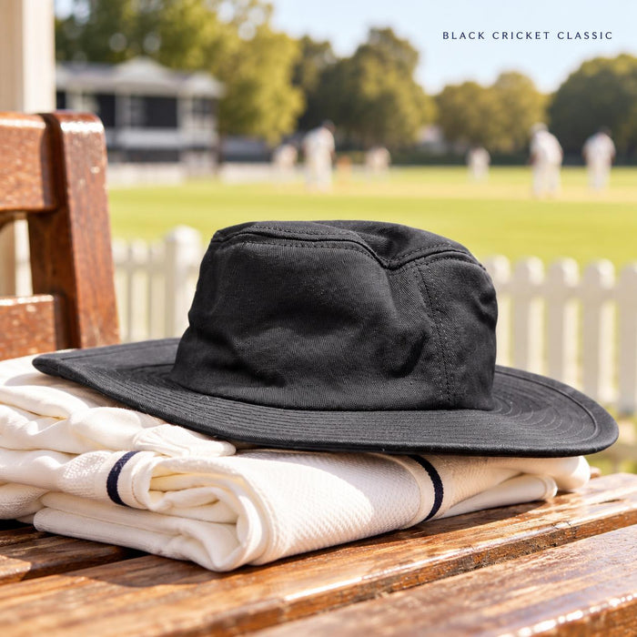 Black CA wide brim cricket Panama hat on folded cricket clothing at the pavilion
