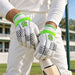 CA BA 56 white and green batting gloves worn while holding a cricket bat