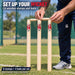 Coach setting wooden bails on CA cricket stumps on a practice pitch