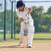 Cricketer using the CA Gold 1000 English Willow Junior Cricket Bat - Size 6 during practice in cricket nets