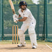 Batter wearing CA Gold 20K white batting leg guards during cricket net practice