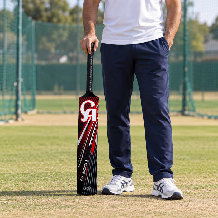 Adult cricketer holding the black CA NJ-8000 fibre bat before tape-ball practice