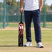 Adult cricketer holding the black CA NJ-8000 fibre bat before tape-ball practice