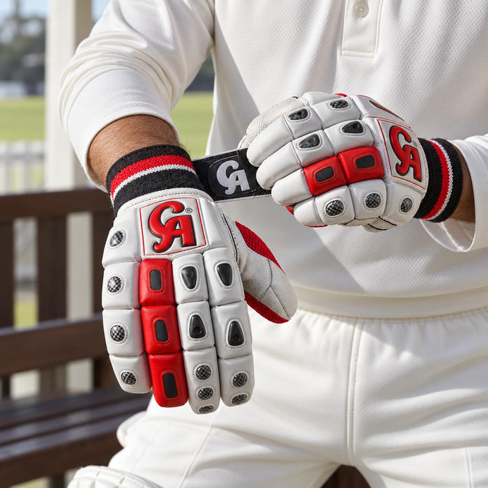 Cricketer fastening the wrist strap of CA Plus 15000 Player Edition batting gloves
