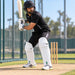 Cricketer wearing CA Pro 10K batting pads with white front, green CA PRO logo and 10K branding in ready batting stance