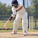 CA Pro 15000 PE white batting leg guards with red CA logo and red rear padding worn by cricketer defending in nets