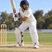 Cricketer wearing CA Pro 15000 PE white front batting pads with red CA logo, red rear mesh and black straps in ready stance