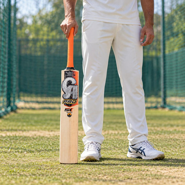 CA PRO 5K English Willow Cricket Bat - SH held upright by a cricketer before practice