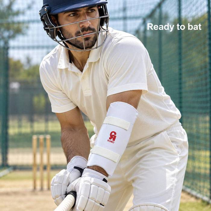 Adult batter wearing a white CA Somo forearm guard with two white straps in cricket nets