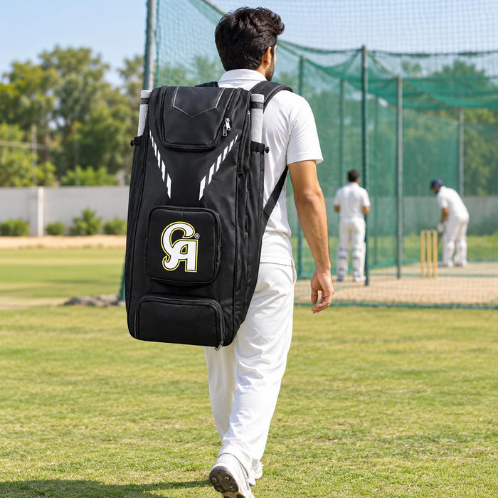 Cricketer carrying a CA Plus 18K black duffle kit bag with both shoulder straps