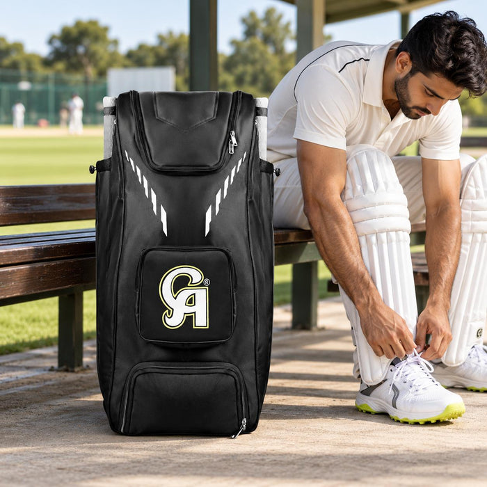CA Plus 18K black cricket duffle kit bag beside a player preparing at the pavilion