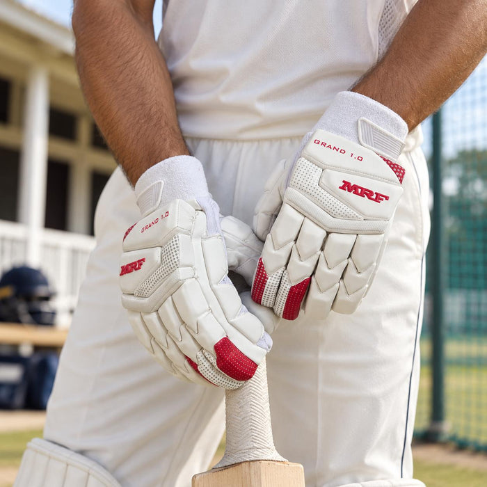 MRF Genius Grand Edition 1.0 batting gloves worn while holding a bat