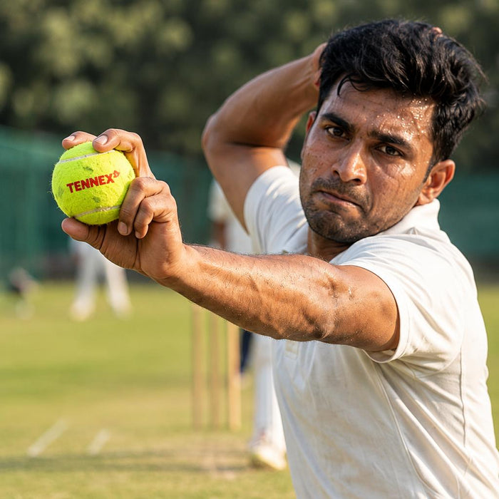 Cricket player holding a green Tennex ball