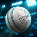 CA Attack white leather cricket ball showing green seam under stadium lights