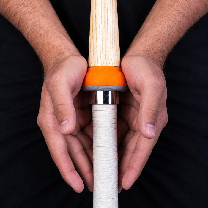 Hands demonstrating grip transfer with cone and bat handle
