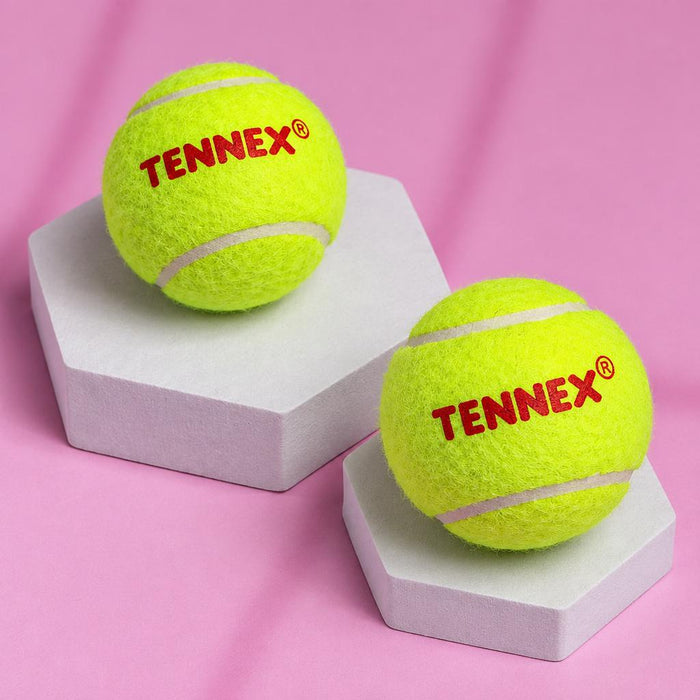 Two green Tennex cricket tennis balls on display stands