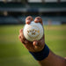SG Super 50 white cricket ball held in hand with wrist and forearm visible