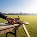 CA League Special red cricket ball on a wooden bench beside cricket equipment