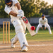 Cricketer batting with a red SG Spark tennis cricket ball