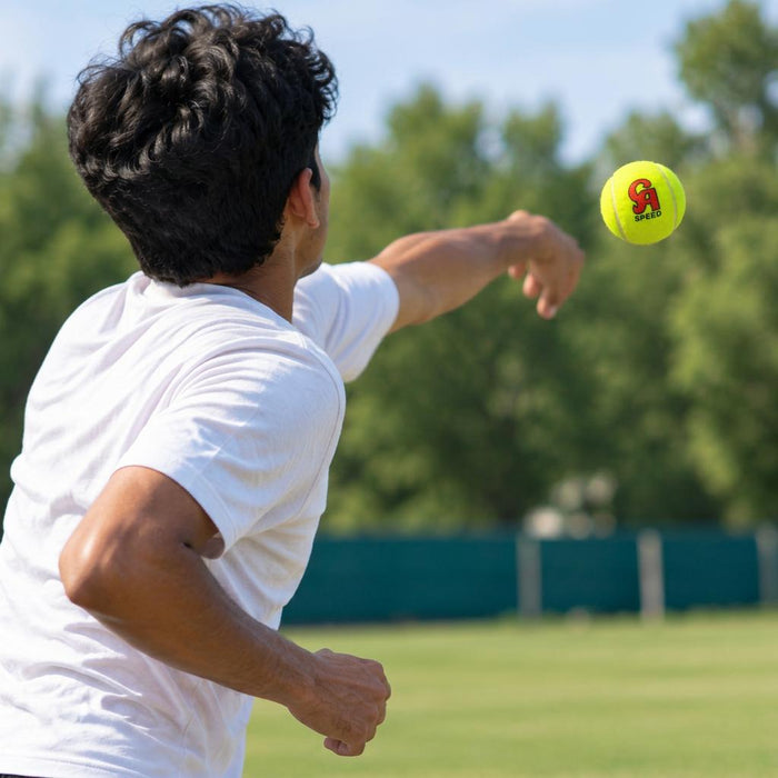 Bowler using a neon yellow CA Speed cricket ball