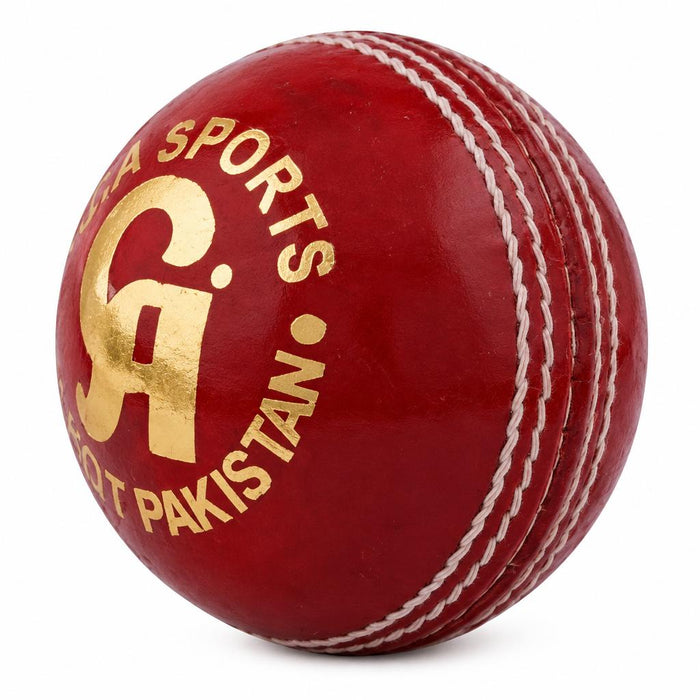 Angled red CA cricket ball showing white seam stitching