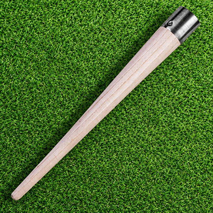 Wooden cricket bat grip cone on grass
