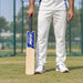 MRF Champion Scoop Kashmir Willow Cricket Bat - SH held upright by a cricketer before practice