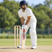 MRF G77 Alpha English Willow Cricket Bat - SH shown held in a batting guard with full cricket protective equipment