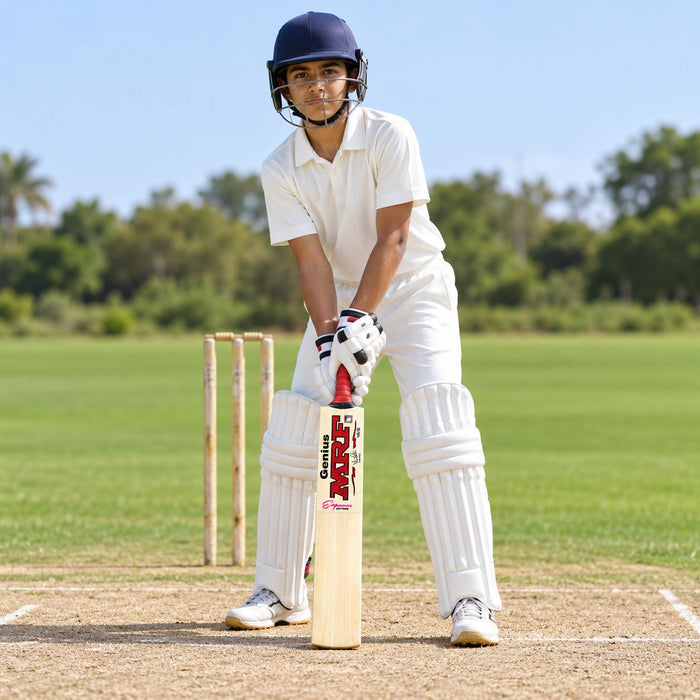 MRF Genius Empower Edition Harrow bat with pink model marking held by a junior batter in full protective equipment