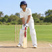 MRF Genius Empower Edition Harrow bat with pink model marking held by a junior batter in full protective equipment