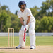 MRF Genius Grand Edition English Willow Cricket Bat - SH shown held in a batting guard with full cricket protective equipment