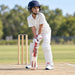 MRF Genius Master Class English Willow Cricket Bat - Junior Size 6 shown held in a batting guard with full cricket protective equipment