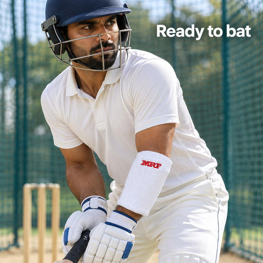 Adult batter wearing a white MRF Genius forearm elbow guard in cricket practice nets