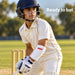 Youth batter wearing a white MRF Genius forearm elbow guard on a cricket ground