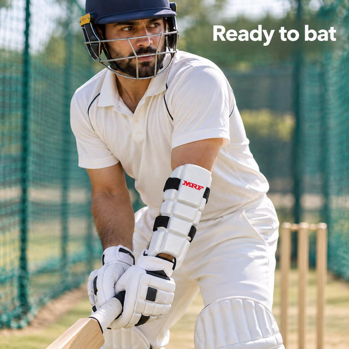 Adult batter wearing the white segmented MRF Molded forearm elbow guard with black straps
