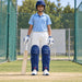MRF Power 2.0 blue batting leg guards worn by a youth cricketer on a practice pitch