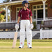 MRF Power 3.0 white batting leg guards worn by a youth cricketer outside the pavilion