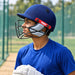 Cricketer in a blue training shirt wearing the MRF Prodigy helmet at practice nets