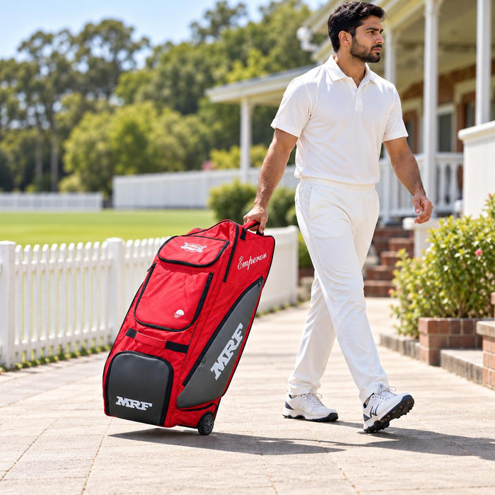 Cricketer pulling the red and grey MRF Genius Emperor cricket kit bag on its wheels