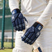 CA Pro 10000 navy batting gloves worn while gripping a cricket bat