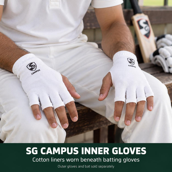 Batter wearing SG Campus white fingerless cotton inner gloves correctly on both hands, with fingertips and thumbs exposed and SG logos on the backs