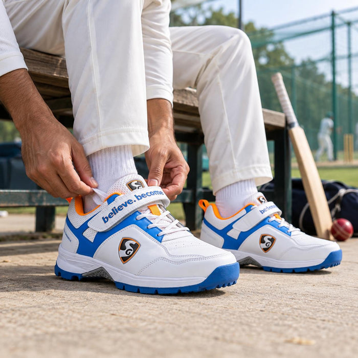 Cricketer wearing SG Century 6.0 White Royal Blue Orange shoes before practice