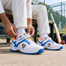 Cricketer wearing SG Century 6.0 White Royal Blue Orange shoes before practice