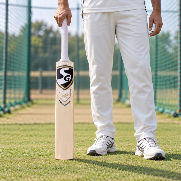 SG Cobra Gold Kashmir Willow Cricket Bat - SH held upright by a cricketer before practice