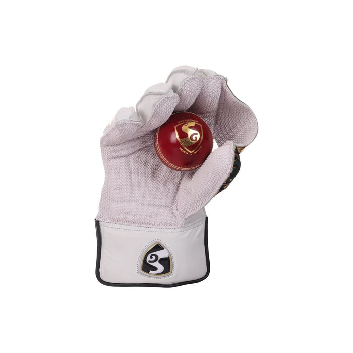 SG Hilite wicket keeping glove cupped around a cricket ball to demonstrate the palm grip and catching area