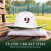 SG Panama Premier 2.0 white cricket hat with red-bordered SG shield and green underside resting on cricket whites beside practice nets