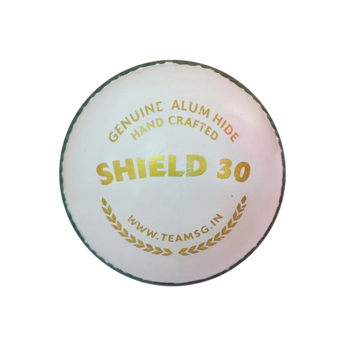 SG Shield 30 white youth cricket ball showing gold model and hand-crafted markings