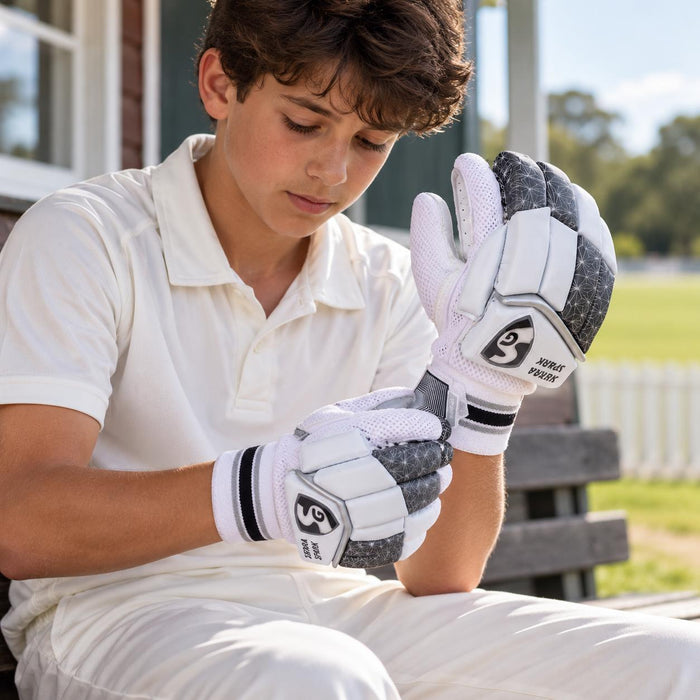 SG Sierra Spark batting gloves worn by a junior cricketer - adjusting the wrist fastening